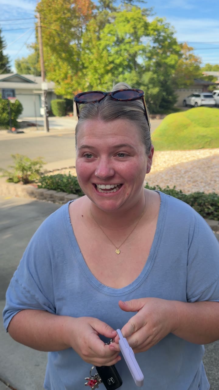 Woman laughing while holding Sally and her keys