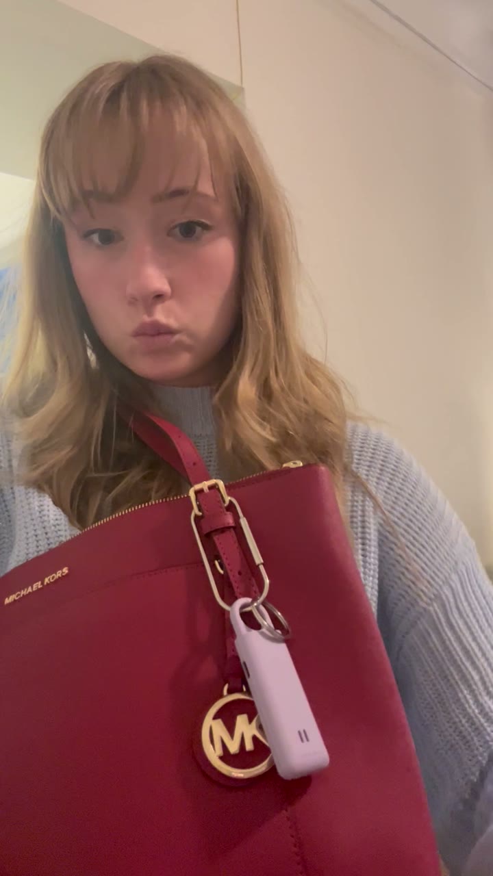 Sally clipped to a red handbag