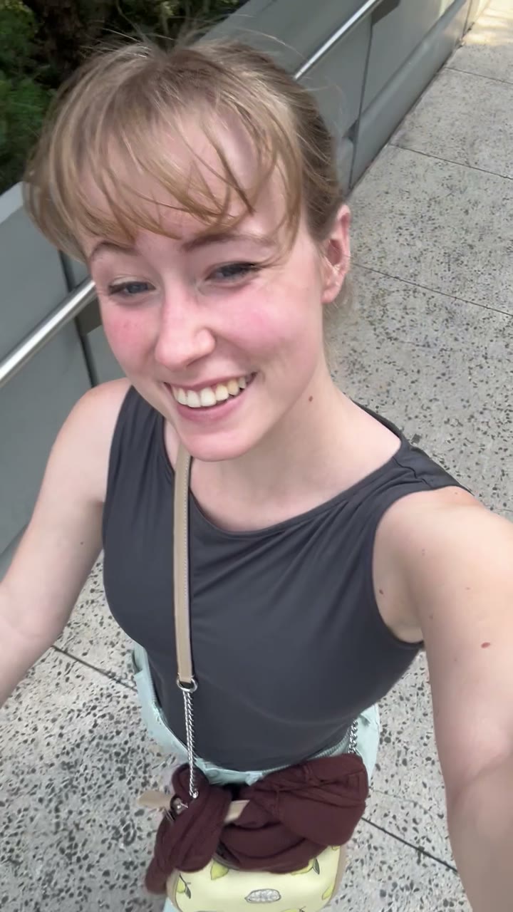 Woman smiling at the camera while out walking with Sally
