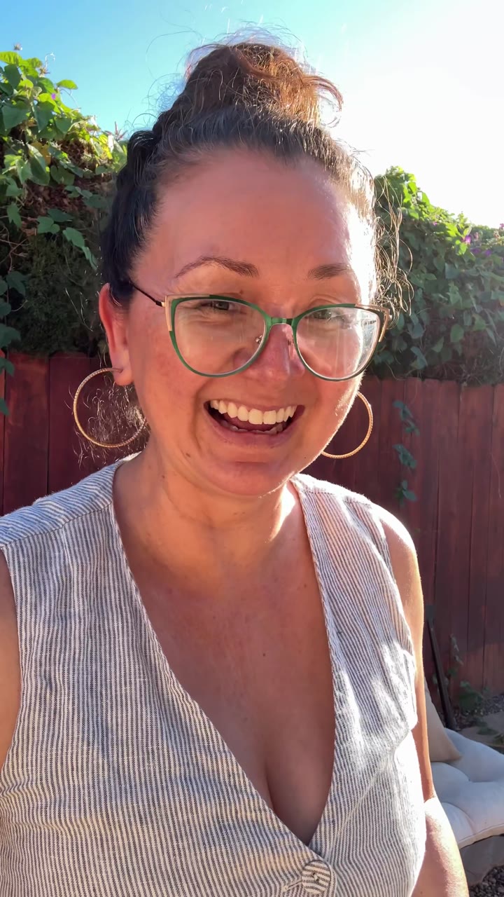 Woman laughing in her backyard